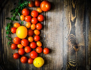 Colorful tomatoes on rustic background